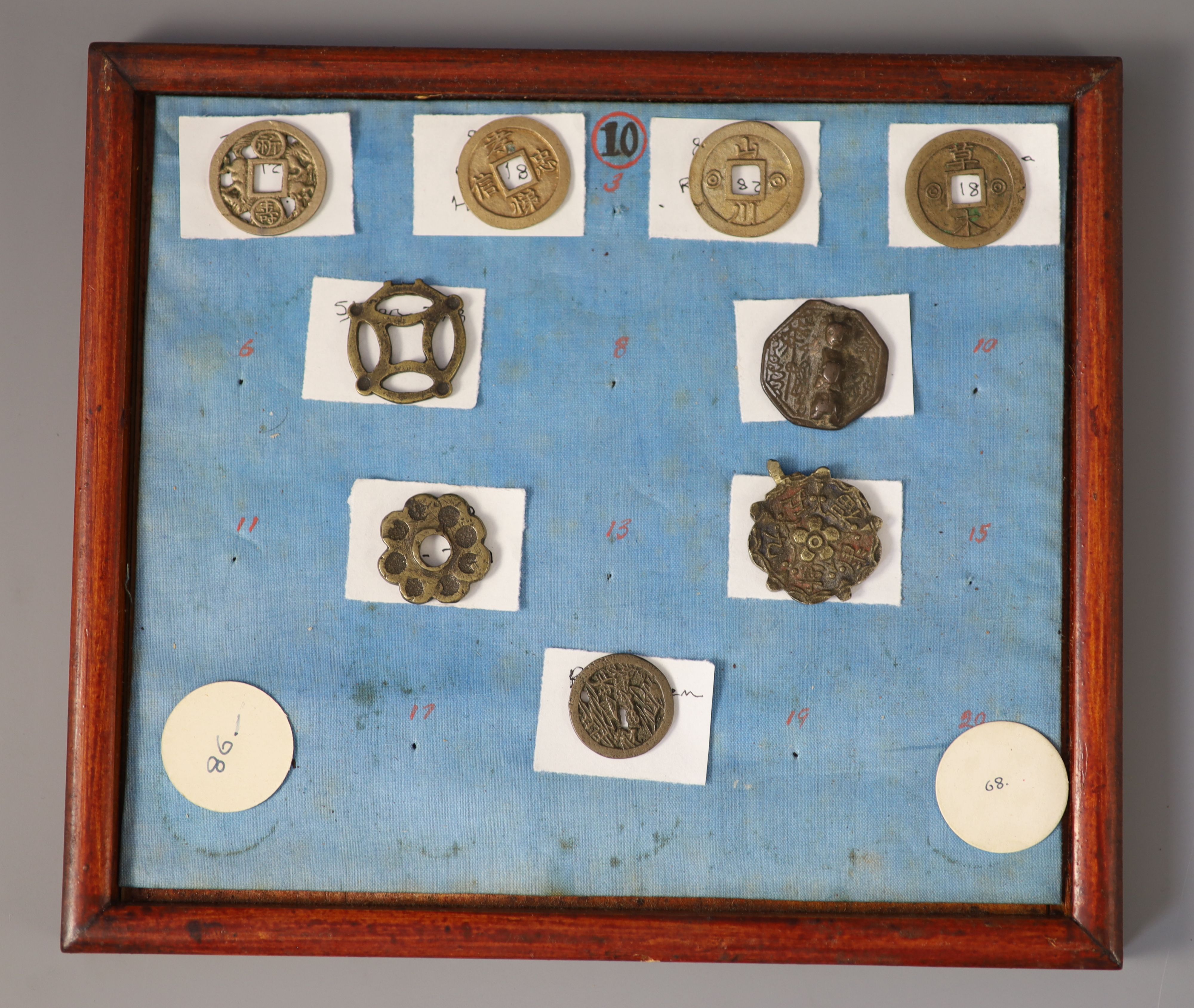 A group of 99 Korean bronze and metal amulets or charms, 19th/20th century